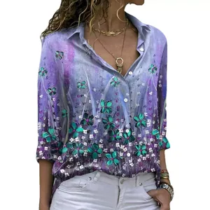 Detail view of women's purple floral long sleeve button-down shirt with green flower print.