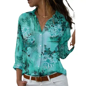 Detailed macro view of teal floral print on women's loose long sleeve button-down shirt