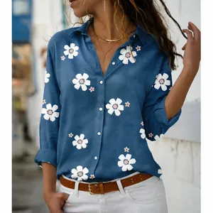 Detailed view of floral print and button-down closure on blue long sleeve blouse