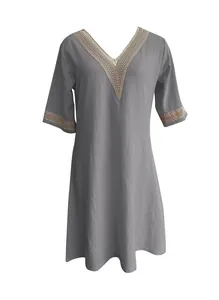 Detailed view of the V-neckline with delicate lace trim on a grey cotton-linen dress.