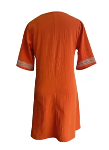 Back view of a casual orange cotton linen dress featuring elegant white lace trim sleeves