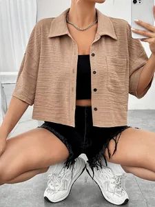 Close-up of khaki textured short-sleeve cropped shirt with button-down collar and pocket