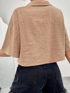 Detailed back view of a brown textured short-sleeved cropped blouse with waffle fabric