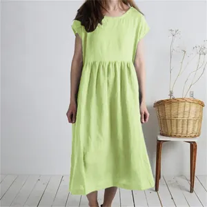 Detail view of a lime green pleated cotton linen maxi dress featuring a loose and casual fit