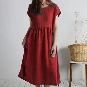 Relaxed fit red cotton linen dress featuring a round neck and pleated waist detail.