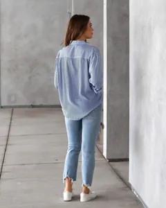 Back view of a casual blue and white vertical striped long sleeve shirt for women