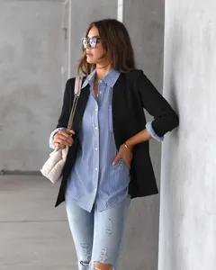 Women's blue and white striped button-down shirt paired with a black blazer