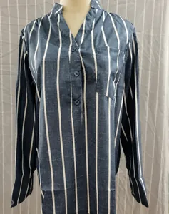 Detailed macro view of women's blue vertical striped long-sleeved blouse with V-neckline