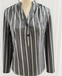 Close-up detail of a grey and white vertical striped women's shirt featuring a V-neck