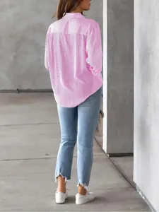 Rear view of a loose pink and white striped long-sleeve button-down shirt for women.
