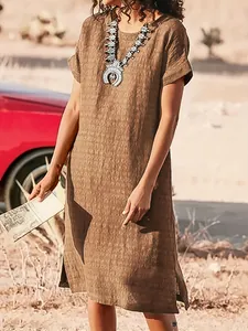 Casual brown short sleeve dress with side slits shown in a desert lifestyle setting.