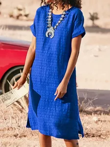Full view of casual blue midi dress with side slits and textured fabric outdoors