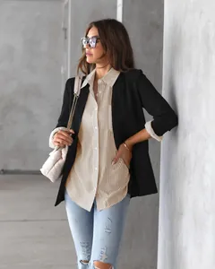 Loose-fit striped long sleeve shirt styled with a black blazer for casual business