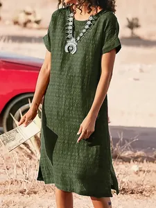 Lifestyle detail of a women's dark green casual short sleeve midi dress with side slit