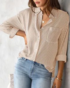 Detail shot of a casual loose striped button-down shirt for women in khaki and white