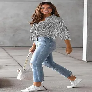 Modern women's black and white striped long-sleeve casual shirt styled with blue jeans