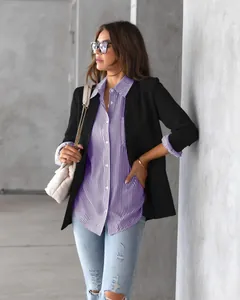 Detailed view of women's purple striped button-down shirt with black blazer styling.