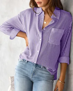 Close-up of women's loose purple striped shirt with chest pocket and white buttons.