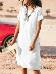 Detailed macro view of white short sleeve casual dress with side slit and round neckline