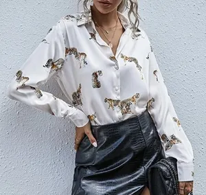 Detailed shot of white silk shirt with tiger print and lapel collar for women