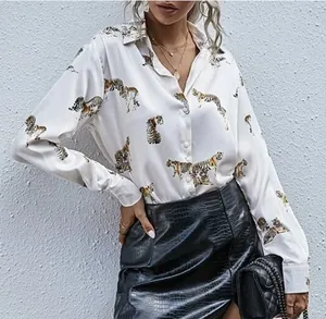 Close-up view of a white long-sleeved silk-feel shirt featuring a vibrant tiger print