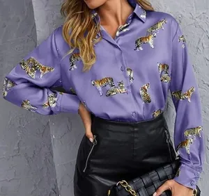 Close-up detail of a purple long-sleeved silk shirt featuring vibrant tiger print patterns