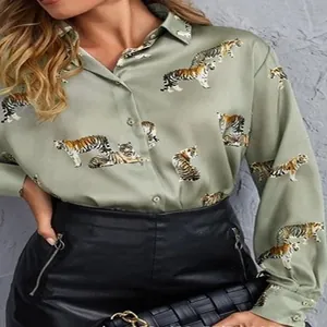 Detail view of women's sage green long-sleeve silk-feel shirt featuring realistic tiger prints