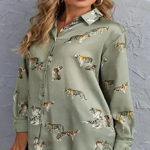 Detail of women's sage green silk-like shirt with realistic tiger print and lapel.