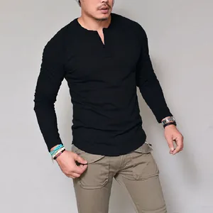Detailed view of men's slim fit black cotton long sleeve Henley T-shirt worn by model