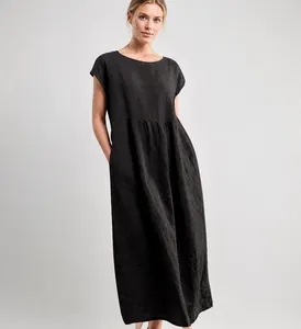 Detailed view of a minimalist dark sleeveless linen dress featuring functional side pockets.