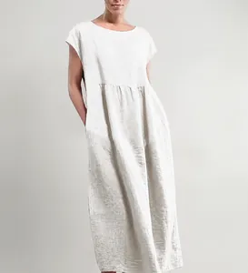 Detail showing the loose silhouette and sleeveless design of the white cotton linen dress