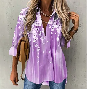 Detail of purple floral print long sleeve blouse featuring front button closure