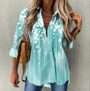 Close-up detail of a women's light blue floral print long-sleeve button-down shirt on a model