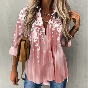 Elegant women's pink floral print long sleeve button-down shirt shown on model.