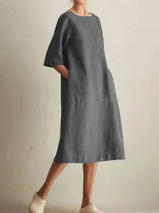 Close-up view of a comfortable loose-fit grey cotton linen dress with side pockets.