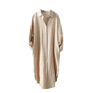 Minimalist oversized beige cotton linen shirt dress with button-down front and pockets.