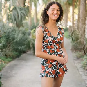 Summer sleeveless romper with orange and leaf print for a casual outdoor look.