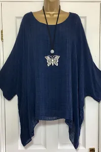 Detail showing the blue textured fabric and irregular hem of this oversized women top