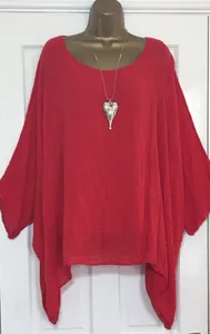 Detailed view of a red linen-texture blouse featuring a stylish asymmetrical hemline.