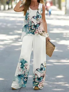 Detailed view of white two-piece set with vibrant butterfly and floral prints