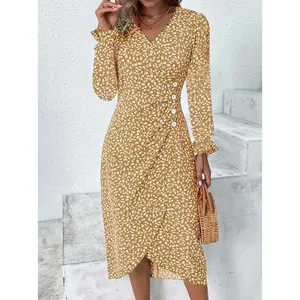 Detail view of mustard yellow floral wrap dress with V-neck and ruffled long sleeves
