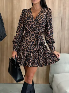 Close-up of leopard print V-neck dress with long bubble sleeves and belted waist