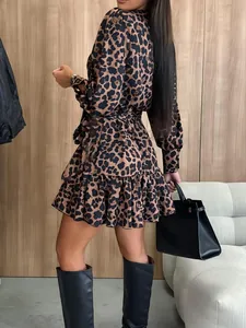 Stylish leopard print puff sleeve mini dress featuring a ruffled hem and waist tie detail.