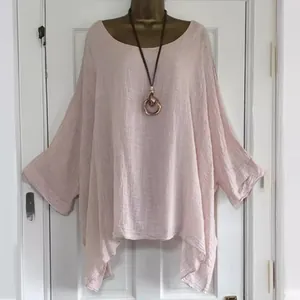 Elegant dusty rose oversized blouse with irregular hem, round neck and long sleeves