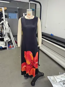 Detailed view of the red floral print on a black sleeveless dress on a mannequin