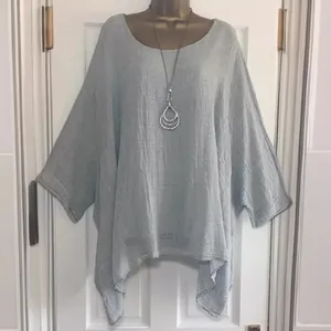 Stylish light blue oversized blouse with irregular hem and soft textured fabric