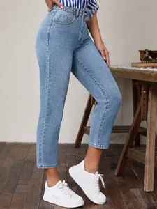 Detail shot of women's vintage high-waisted elastic slim jeans in light blue denim.