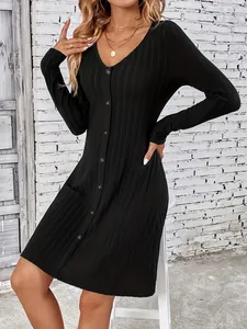 Elegant black ribbed long-sleeve dress with button detailing and a cinched waist.