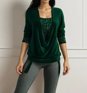 Close-up of women's dark green long sleeve top with sequin detail and draped collar