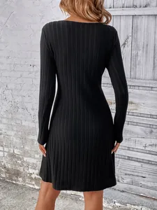 Back view of a slim-fit black ribbed long-sleeve dress showing knit texture details